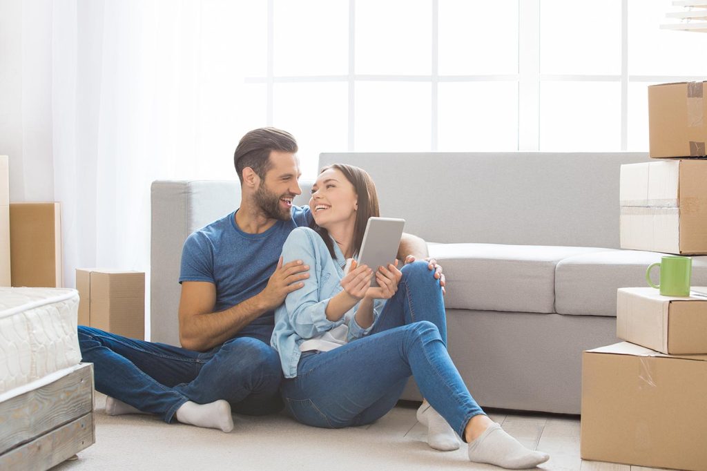 Young Couple Sitting On The Floor